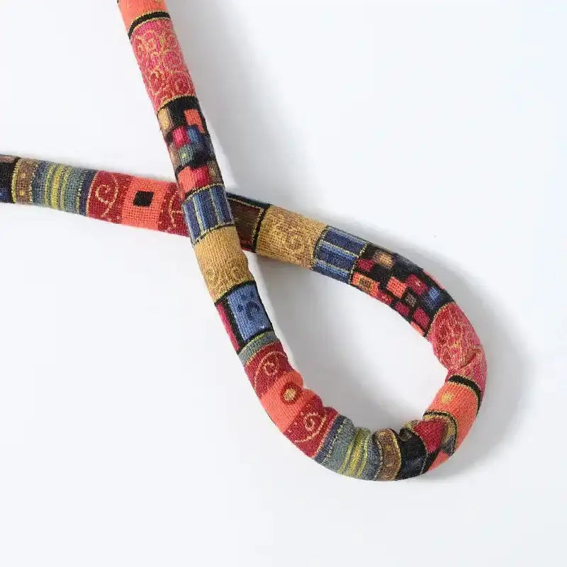 Colorful woven belt with geometric patterns on a white background